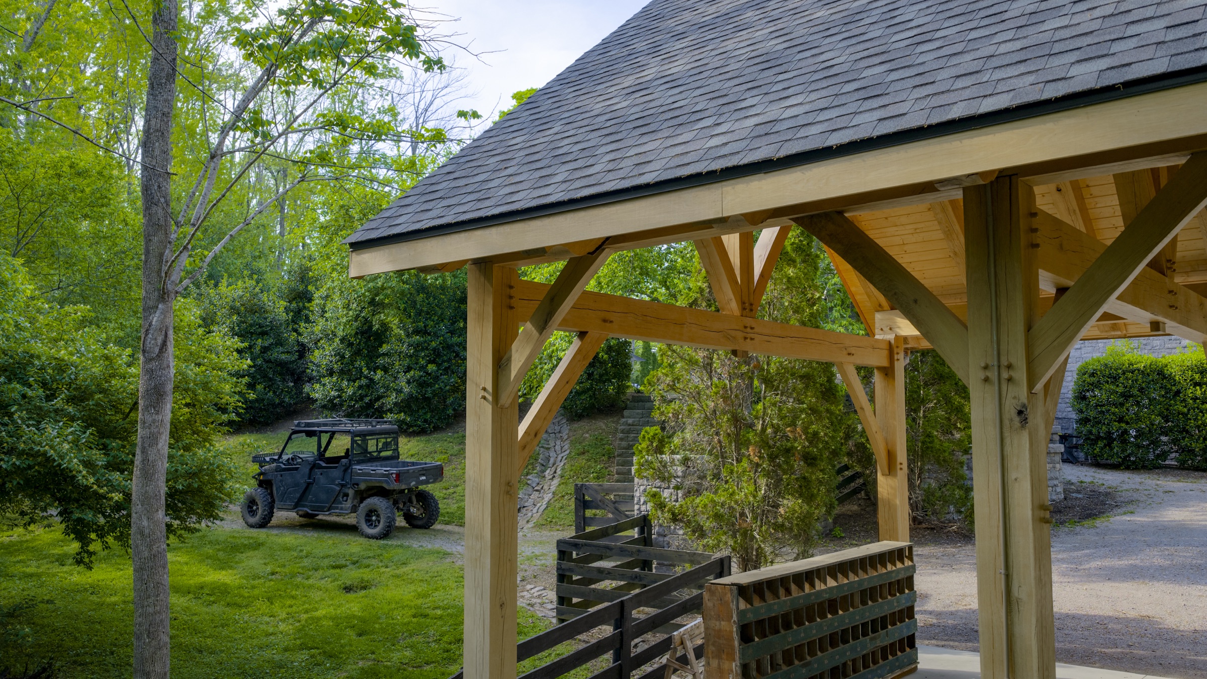 Wide site view of stone workshop among trees