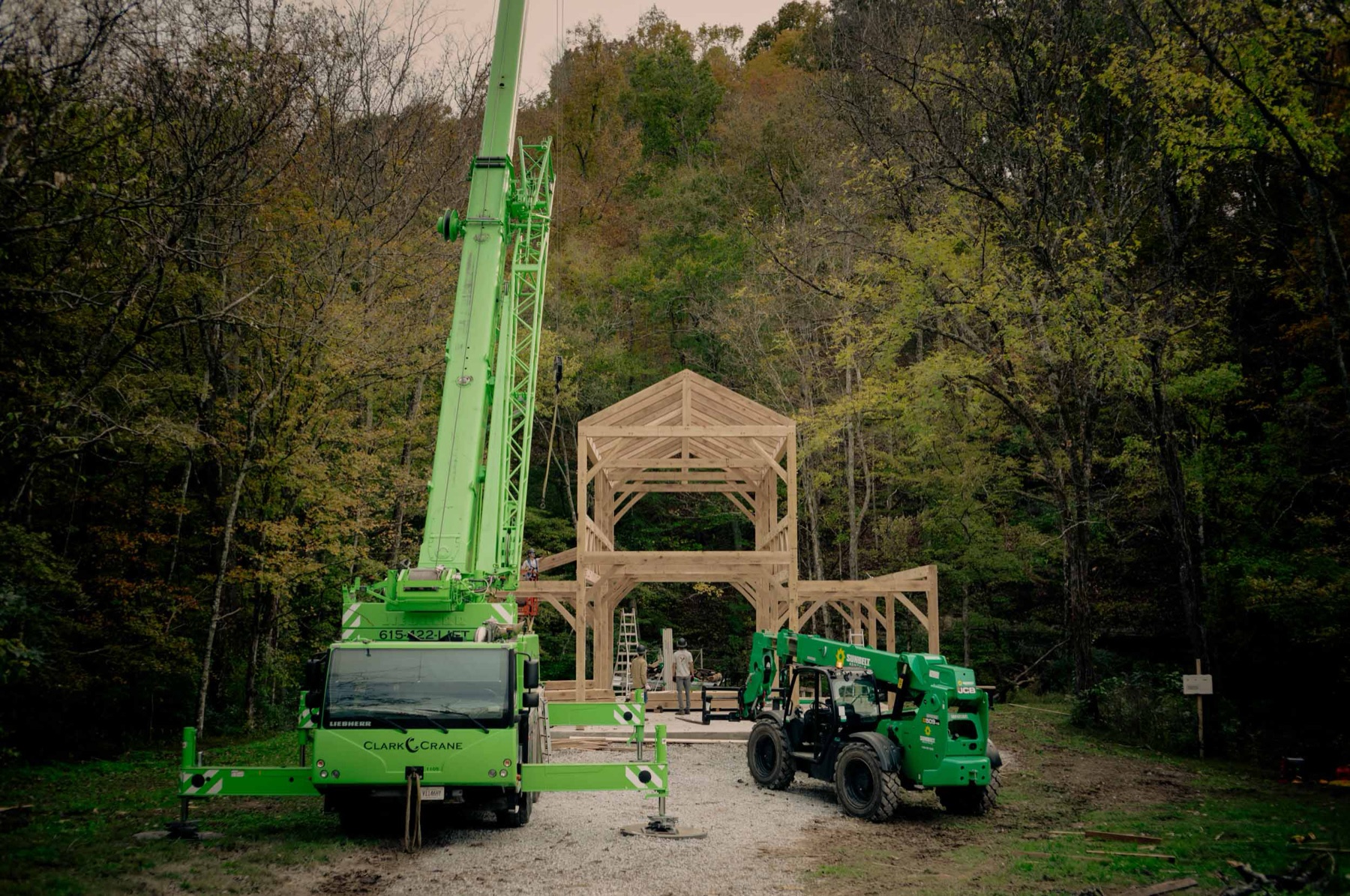 Traditional timber barn raising in a rural setting